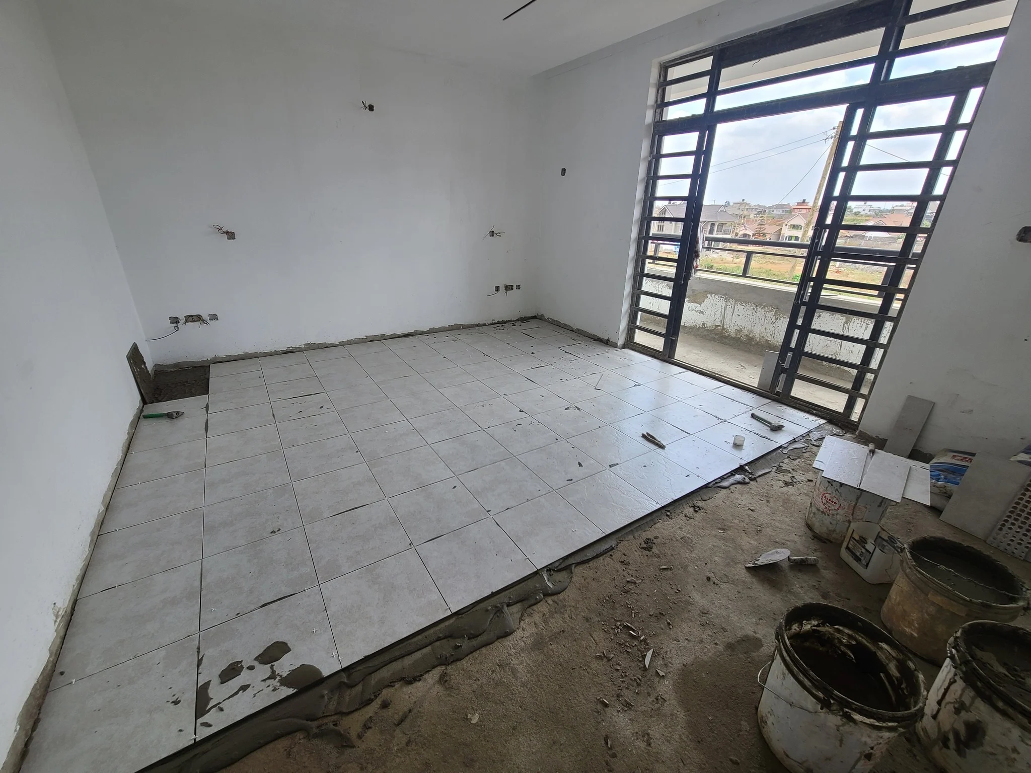 image of fundis installing tiles in a 3 bedroom house in eldoret